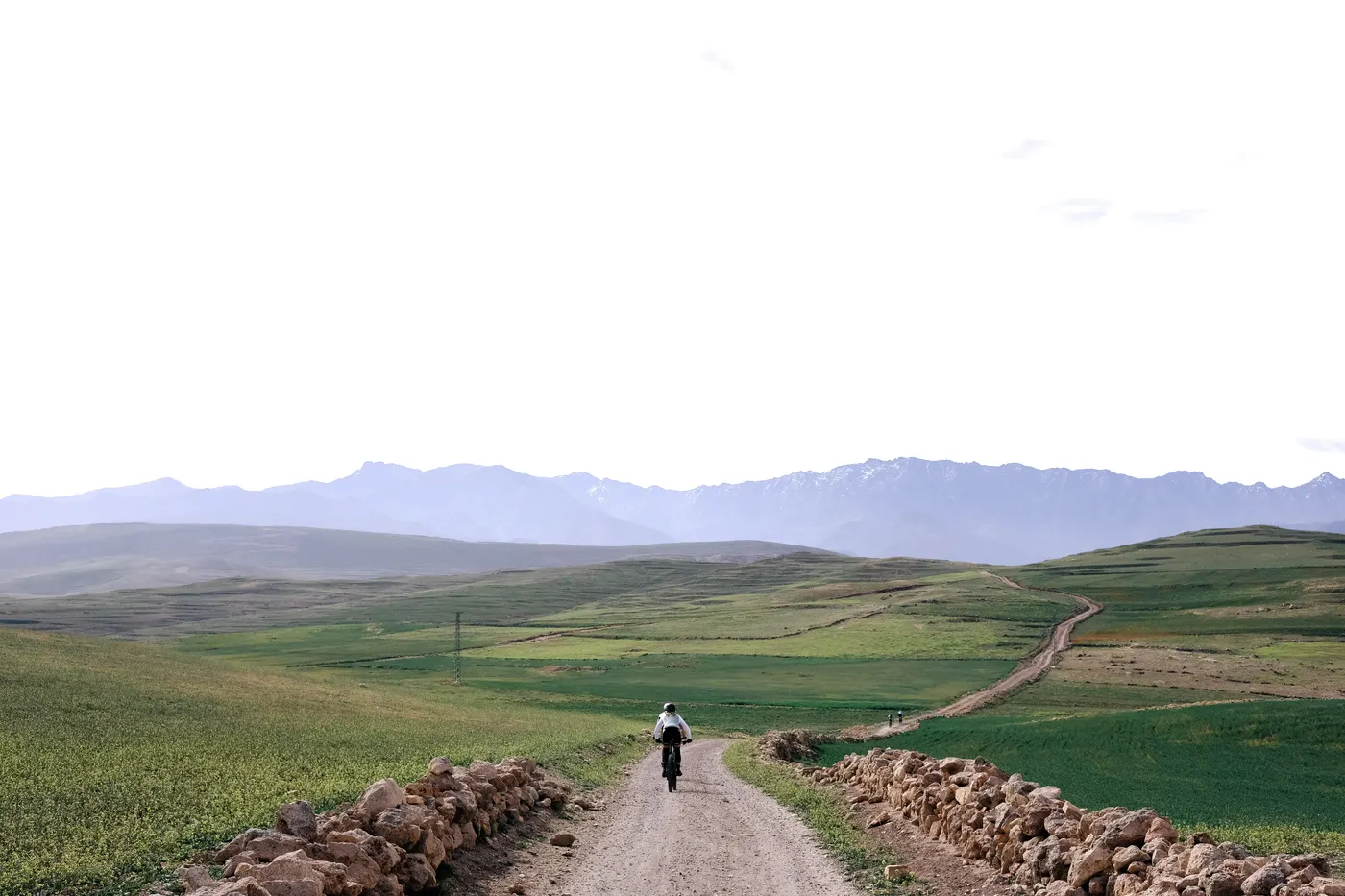 A gravel rider on a dirt track through the foothills of the High Atlas, Morocco