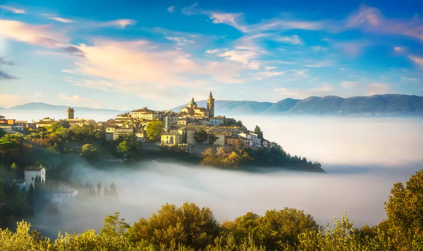 The hill town of Trevi stacked above olive terraces in the Umbrian valley